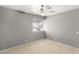 Gray bedroom features a ceiling fan and a window with natural light at 4197 Tolkien Ave, Las Vegas, NV 89115
