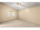 A neutral bedroom features a ceiling fan and a window with natural light at 4197 Tolkien Ave, Las Vegas, NV 89115