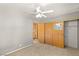 Gray bedroom features a closet with sliding doors and access to stairs at 4197 Tolkien Ave, Las Vegas, NV 89115