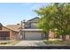 Charming gray two-story home features a two-car garage and mature landscaping in a desirable neighborhood at 4197 Tolkien Ave, Las Vegas, NV 89115