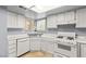 Well-lit kitchen boasts white appliances and a view from the window at 4197 Tolkien Ave, Las Vegas, NV 89115