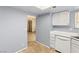 Galley kitchen featuring white appliances and light-colored tile flooring at 4197 Tolkien Ave, Las Vegas, NV 89115