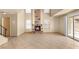 Open-concept living room with tile flooring, fireplace, and natural light at 4197 Tolkien Ave, Las Vegas, NV 89115