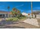 Expansive backyard featuring desert landscaping, a stone patio, and block wall fencing at 4212 Herblinda Ln, North Las Vegas, NV 89032
