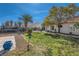 Large backyard with mature trees, grass, playground, trampoline and stone walkway at 4212 Herblinda Ln, North Las Vegas, NV 89032