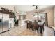 Bright dining area with tile floors, a glass top table with seating for six, and sliding glass doors to the backyard at 4212 Herblinda Ln, North Las Vegas, NV 89032