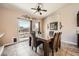 Bright dining area featuring tile floors, a glass top table with seating for six, and sliding glass doors to the backyard at 4212 Herblinda Ln, North Las Vegas, NV 89032