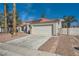 Single-story home with a two-car garage and a well-maintained driveway, showcasing desert landscaping at 4212 Herblinda Ln, North Las Vegas, NV 89032