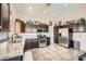 Well-lit kitchen featuring stainless steel appliances, granite countertops, tile flooring, and ample cabinet space at 4212 Herblinda Ln, North Las Vegas, NV 89032