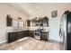 Well-lit kitchen featuring stainless steel appliances, granite countertops, tile flooring, and ample cabinet space at 4212 Herblinda Ln, North Las Vegas, NV 89032