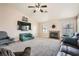 Cozy living room featuring carpet, a fireplace, a ceiling fan, and comfortable seating arrangements at 4212 Herblinda Ln, North Las Vegas, NV 89032