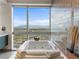 Luxurious bathroom with soaking tub, city view, and tiled accent wall at 4471 Dean Martin Dr # 4308, Las Vegas, NV 89103