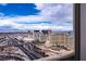 Expansive city view from a balcony showcasing luxury hotels and busy highways under a bright blue sky at 4471 Dean Martin Dr # 4308, Las Vegas, NV 89103