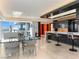Dining area with glass table and chairs, adjacent to a sleek kitchen with bar seating and decorative lighting at 4471 Dean Martin Dr # 4308, Las Vegas, NV 89103
