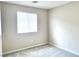 Neutral bedroom with light gray carpet, a window with blinds, and ample natural light at 5060 Serene Skies St, Las Vegas, NV 89130