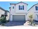 Charming two-story home featuring a gray garage door, neutral color scheme, and well-maintained landscaping at 5060 Serene Skies St, Las Vegas, NV 89130