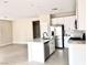 Open-concept kitchen with stainless steel appliances, a center island, and stylish white cabinets at 5060 Serene Skies St, Las Vegas, NV 89130
