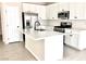 Well-equipped kitchen featuring a spacious island, modern stainless steel appliances, and white cabinetry at 5060 Serene Skies St, Las Vegas, NV 89130