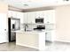 Bright, spacious kitchen with stainless steel appliances, a kitchen island, and ample cabinet space at 5060 Serene Skies St, Las Vegas, NV 89130