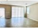 Spacious living room featuring modern tile flooring, neutral wall color, and natural light from sliding glass doors at 5060 Serene Skies St, Las Vegas, NV 89130