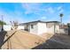 The backyard shows a covered patio, low-maintenance landscaping, a gate, and perimeter fencing at 5069 Hallet Dr, Las Vegas, NV 89122