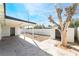This backyard features a covered patio, a storage shed, a mature tree, and a fenced yard at 5069 Hallet Dr, Las Vegas, NV 89122