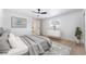 Staged bedroom showcasing neutral decor, a ceiling fan and wood-look floors at 5069 Hallet Dr, Las Vegas, NV 89122