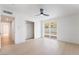 Bright bedroom with updated closet, light floors, ceiling fan, and sliding glass door to the backyard at 5069 Hallet Dr, Las Vegas, NV 89122
