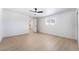 Bright bedroom with wood floors, ceiling fan, and a hallway to the kitchen at 5069 Hallet Dr, Las Vegas, NV 89122