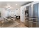 Staged dining room with modern table setting, stainless refrigerator and light-colored wood floors at 5069 Hallet Dr, Las Vegas, NV 89122