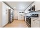 Modern kitchen with stainless steel appliances, white cabinets, and a sleek countertop at 5069 Hallet Dr, Las Vegas, NV 89122