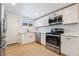 Bright kitchen features stainless steel appliances, white cabinets and light hardwood flooring at 5069 Hallet Dr, Las Vegas, NV 89122