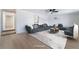Spacious living room featuring stylish furnishings, a modern ceiling fan and light, hardwood floors at 5069 Hallet Dr, Las Vegas, NV 89122