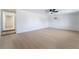 Bright living room with wood floors, ceiling fan, and an entrance to the hallway at 5069 Hallet Dr, Las Vegas, NV 89122
