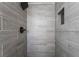 Close up of renovated tiled shower with rain shower head at 5069 Hallet Dr, Las Vegas, NV 89122