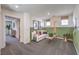 An open bonus room with carpeted flooring, soft couch and playful decor at 5722 Sunset Sedona St # Lot 7, North Las Vegas, NV 89081