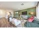 Bright living room with white chairs, green sofa, and modern decor at 5722 Sunset Sedona St # Lot 7, North Las Vegas, NV 89081