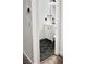Stylish powder room with hexagon tile flooring, white vanity, and modern fixtures at 649 Ryan Peak Ln, Henderson, NV 89011
