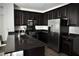 Well-equipped kitchen featuring dark cabinetry, stainless steel appliances, and granite countertops at 649 Ryan Peak Ln, Henderson, NV 89011