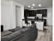 Cozy living space with sleek black kitchen cabinets and an inviting open-concept design at 649 Ryan Peak Ln, Henderson, NV 89011