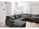 Comfortable living room showcasing a plush gray sectional couch and plenty of natural light at 649 Ryan Peak Ln, Henderson, NV 89011
