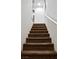 Carpeted staircase leading upstairs, featuring a white railing and textured walls at 649 Ryan Peak Ln, Henderson, NV 89011