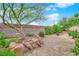 Backyard with gravel, landscaping, rocks, bushes, plants and a brick fence at 6781 Alpine Brooks Ave, Las Vegas, NV 89130