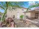 Backyard with desert landscaping, seating area under a covered patio, and access to the building at 6781 Alpine Brooks Ave, Las Vegas, NV 89130