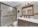 Modern bathroom with a glass shower, vanity with drawers, and new light fixture at 6781 Alpine Brooks Ave, Las Vegas, NV 89130