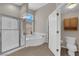 Bright primary bathroom featuring tiled floors, a shower, and a soaking tub at 6781 Alpine Brooks Ave, Las Vegas, NV 89130