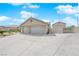 Charming property showcasing an expansive driveway leading to the garages and a decorative gate at 6781 Alpine Brooks Ave, Las Vegas, NV 89130