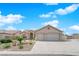 Inviting single-story home featuring a manicured yard and a spacious two-car garage and driveway at 6781 Alpine Brooks Ave, Las Vegas, NV 89130