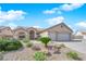 Beautiful front exterior showcasing a charming home, well-maintained landscaping, and a two-car garage at 6781 Alpine Brooks Ave, Las Vegas, NV 89130