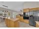 Featuring a kitchen island, granite countertops, wood cabinets, and stainless steel appliances at 6781 Alpine Brooks Ave, Las Vegas, NV 89130